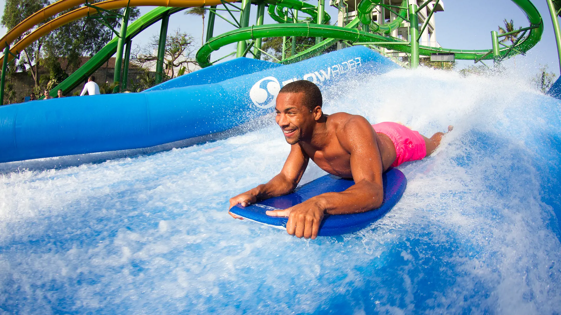 Surfer riding the FlowRider standing wave at Waterbom Bali